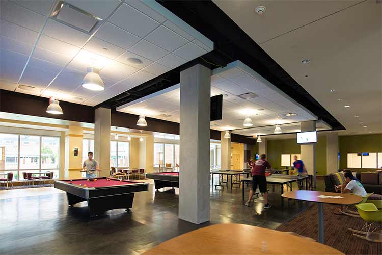 Game room of Hullabaloo Hall: two pool tables, two table tennis tables, study areas near the hallway of the game room area, and study tables in the game room. 