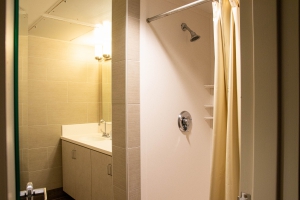 Commons Hall suite style bathroom with walk in shower with basic shower curtain included