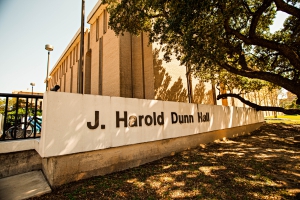 J. Harold Dunn Hall sign with Dunn Hall in the background.