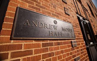 Plaque of Moses Hall stating its namesake, “Andrew Moses” Hall on the exterior of the building