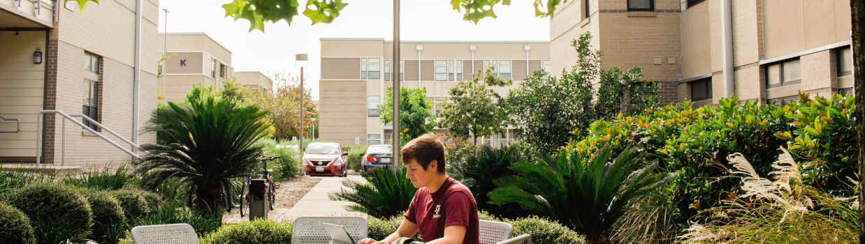 Exterior of the Gardens Apartments during the day.