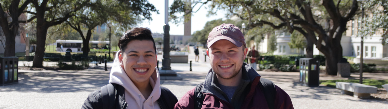 Two male students smiling at the camera.